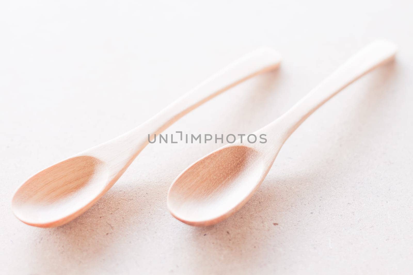 Wooden spoons on brown background, stock photo