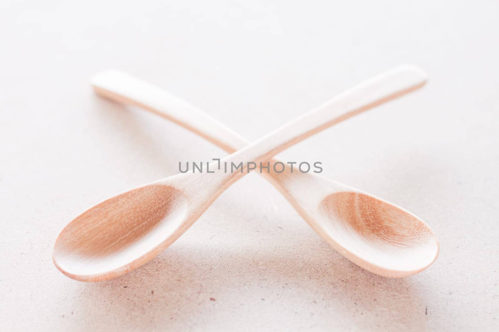 Empty spoons on brown background, stock photo