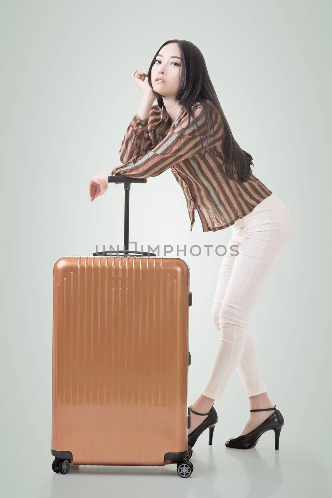 Modern Asian woman stand with a luggage.