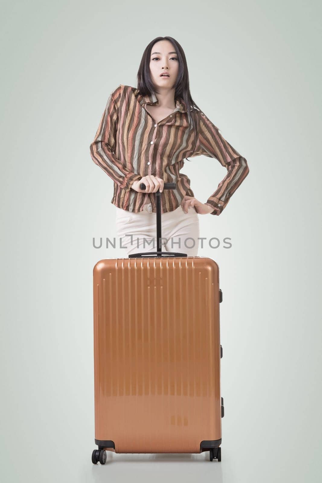 Modern Asian woman stand with a luggage.