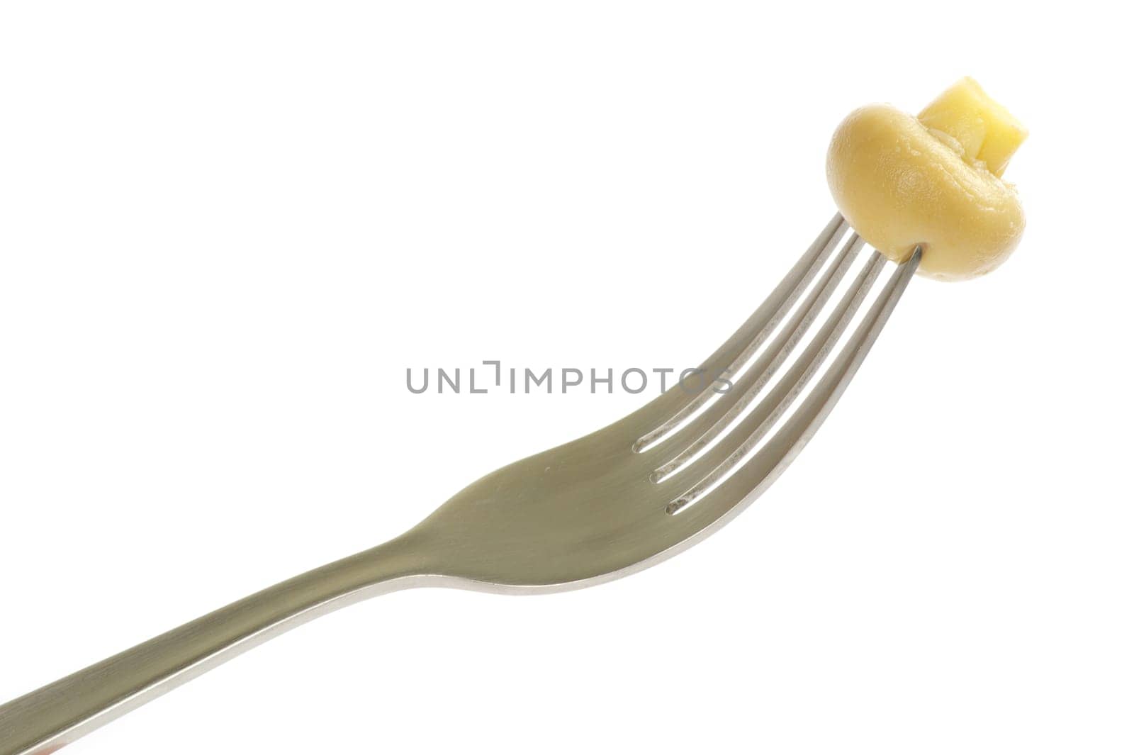 Fresh mushroom on a fork isolated on white background