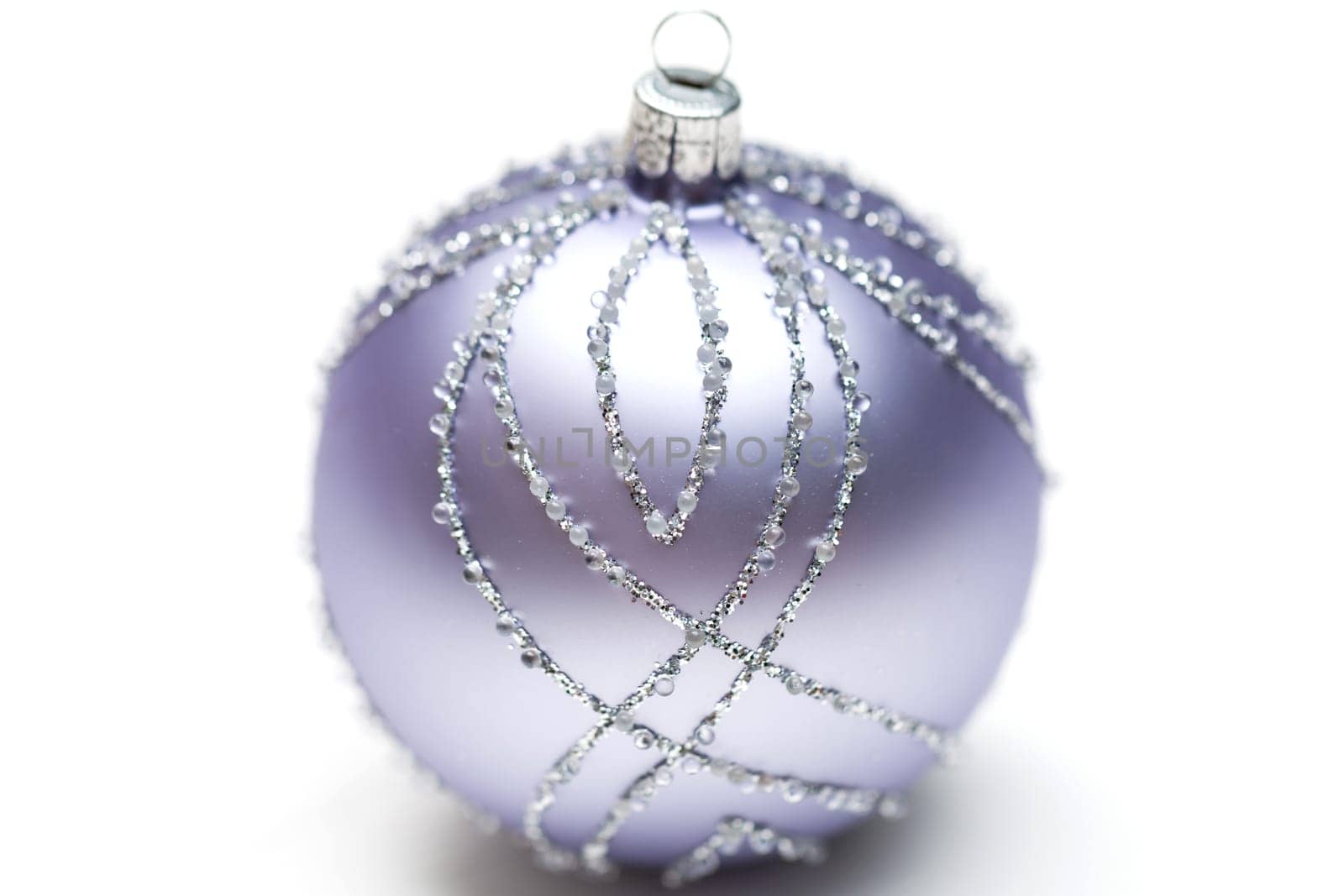 Glittering silver Christmas bauble on white background Macro detail