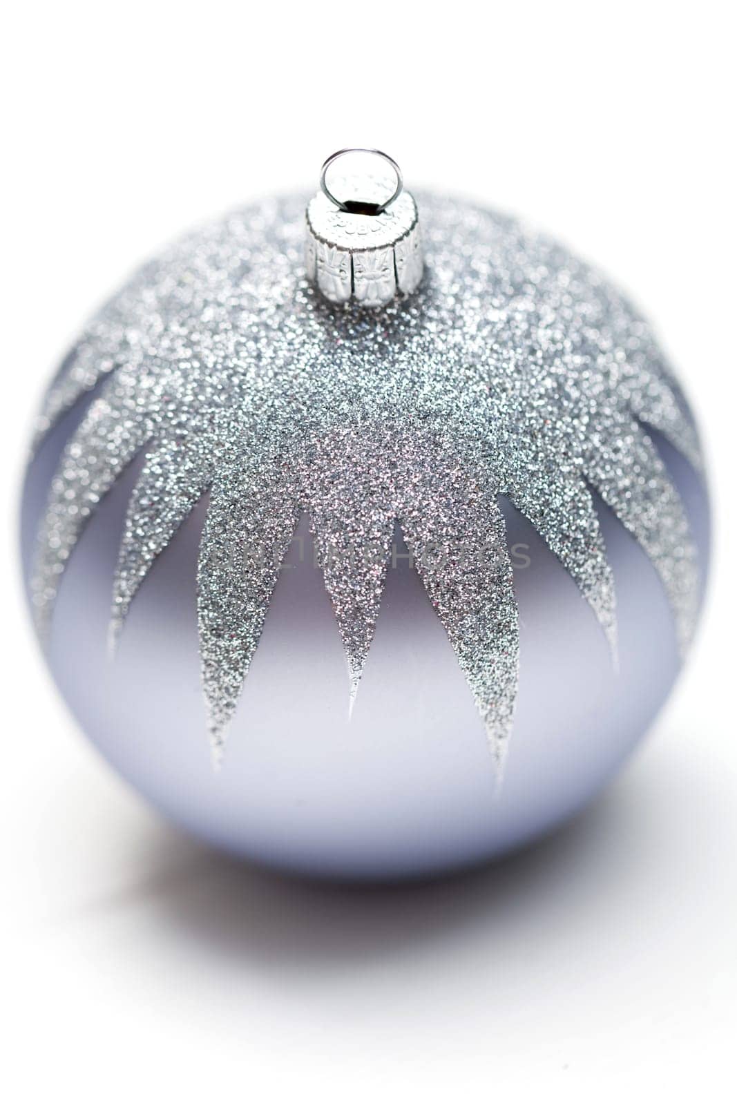 Glittering silver Christmas bauble on white background Macro detail