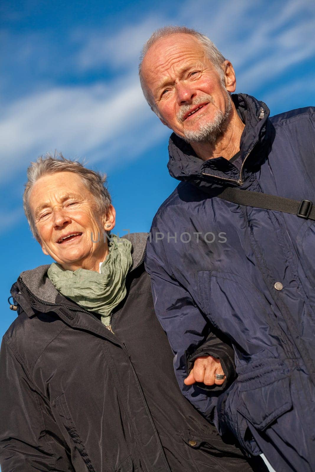 older happy couple makes a beach walk in autumn baltic sea landscape sea