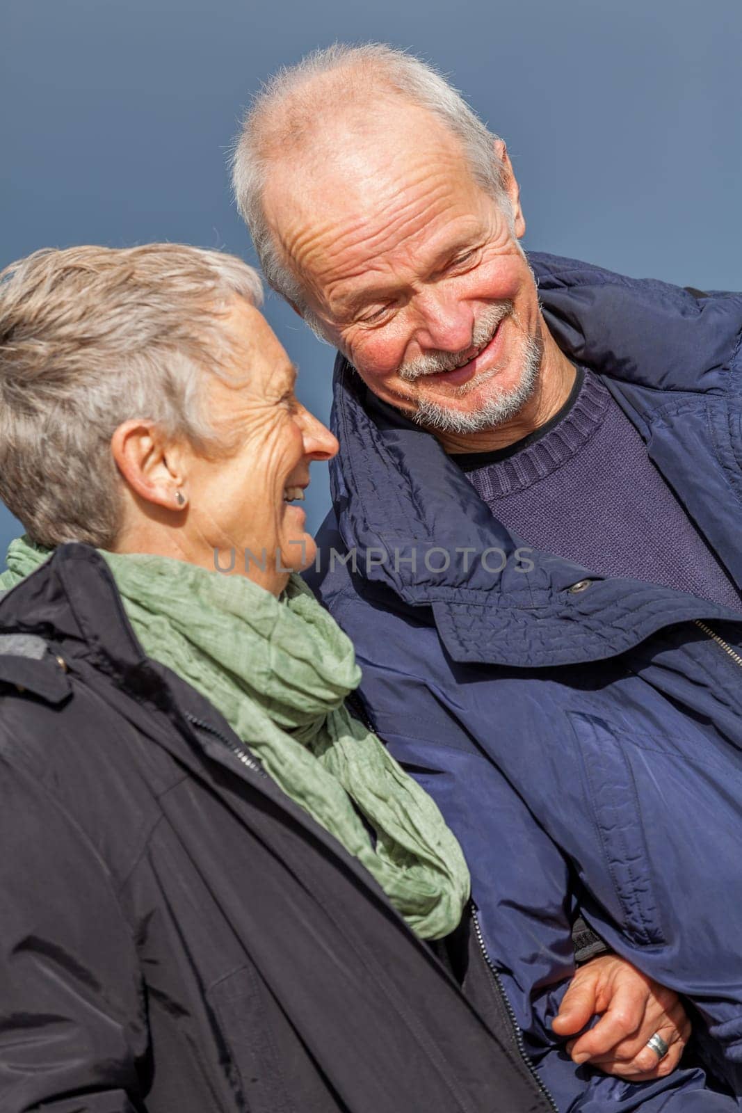 older adult happy couple walks on the beach in autumn lifestyle happiness