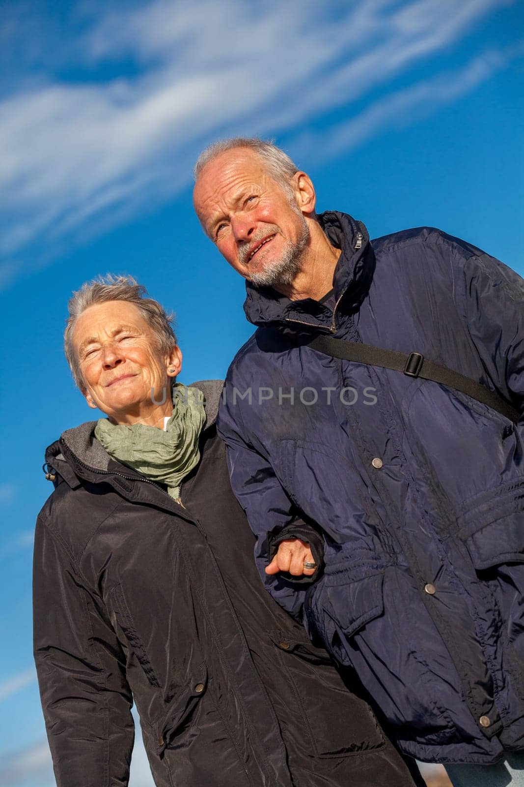 older happy couple makes a beach walk in autumn baltic sea landscape sea