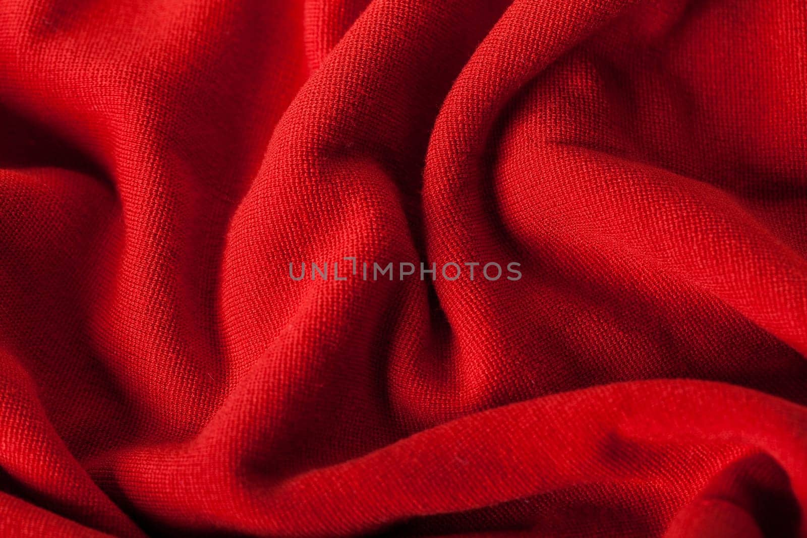 Structure of a red soft fabric as close-up texture