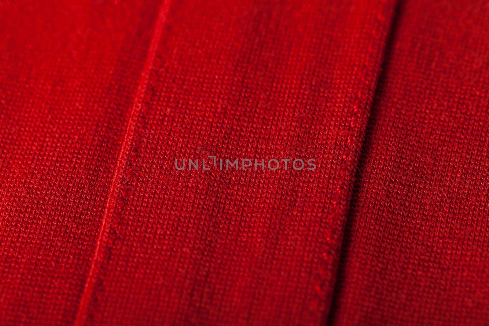 Structure of a red soft fabric as close-up texture