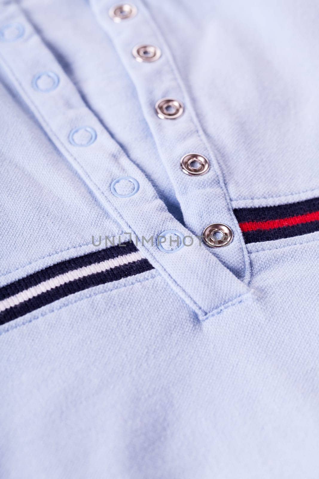Shirt with button placket with silver snaps and stripes texture as close-up background