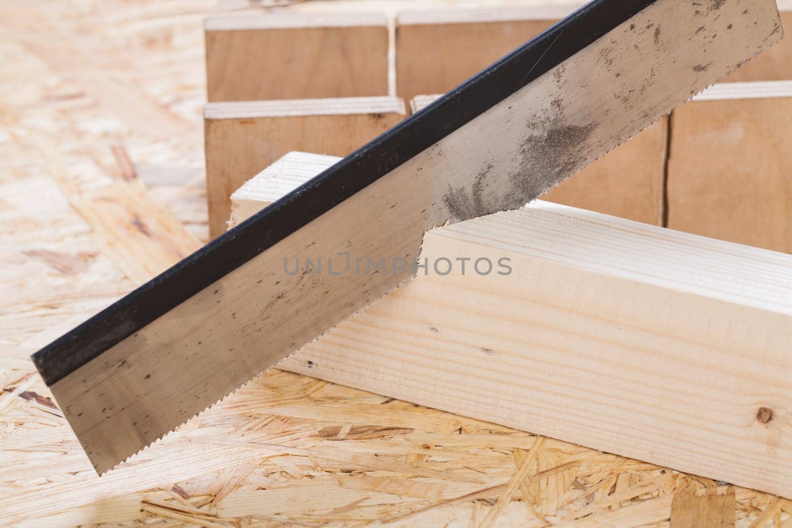 Wood with angle cutter and saw in a workshop close-up detail