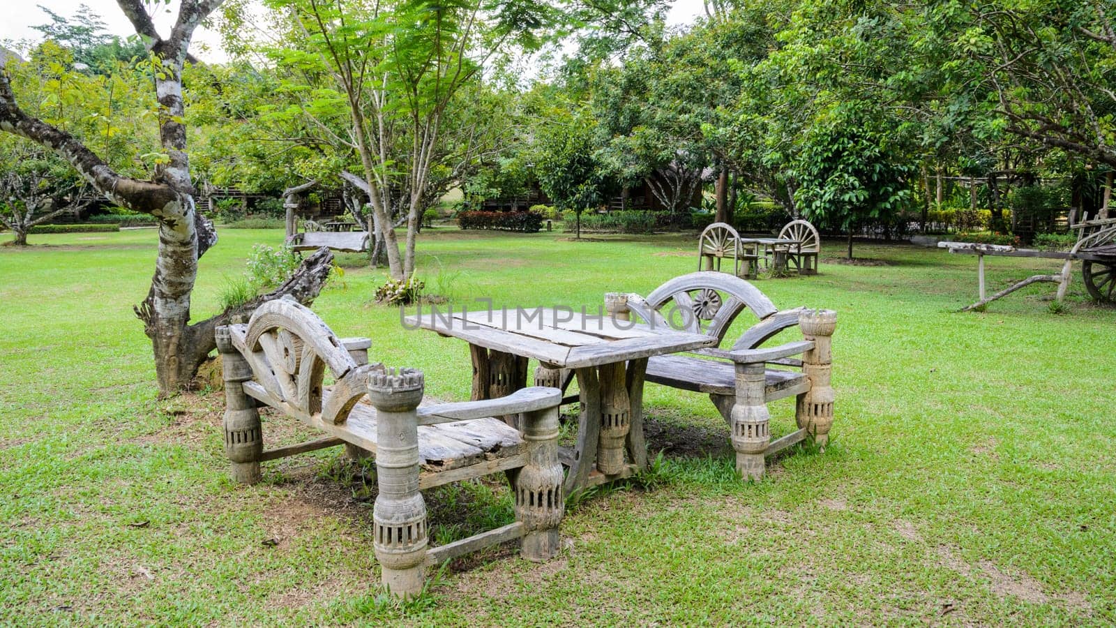 Old wooden tables and bench for relaxing in the park