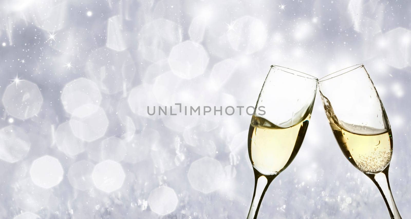 Champangne glasses on sparkling background