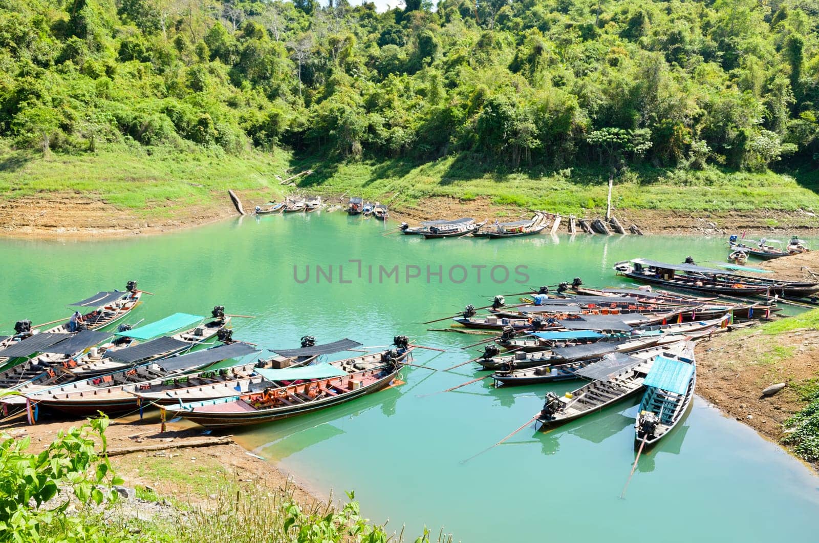 Group long-tail boat waiting for the tourists. Ratchaprapa or Chiao Lan Dam , Surat Thani Province Thailand.