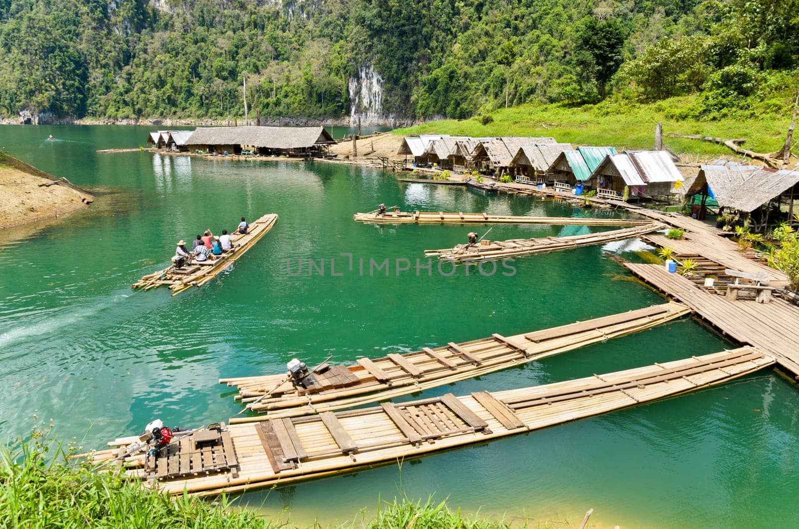 SURAT THANI, THAILAND - APR 26, 2013 : The arrival of tourists to go visit the stalactite cave by motor raft in Ratchaprapha Dam at Khao Sok National Park, APR 26, 2013 in Thailand