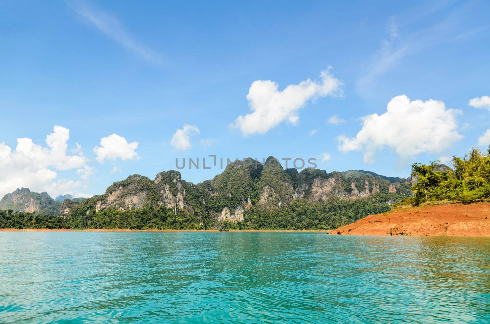 High mountain range above the green lake at Ratchapapha dam in Khao Sok National Park, Surat Thani province, Guilin of Thailand.