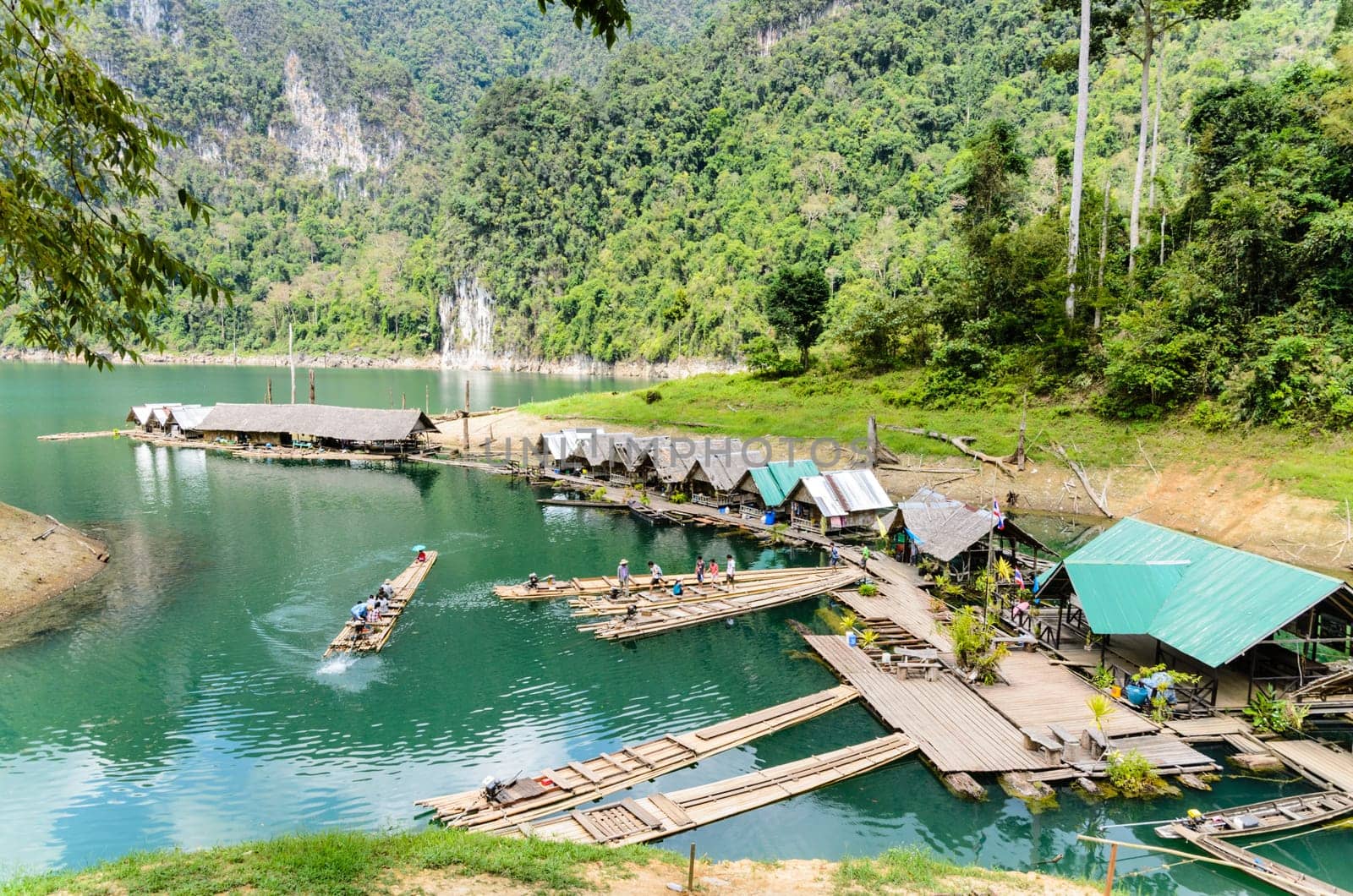 SURAT THANI, THAILAND - APR 26, 2013 : The arrival of tourists to go visit the stalactite cave by motor raft in Ratchaprapha Dam at Khao Sok National Park, APR 26, 2013 in Thailand