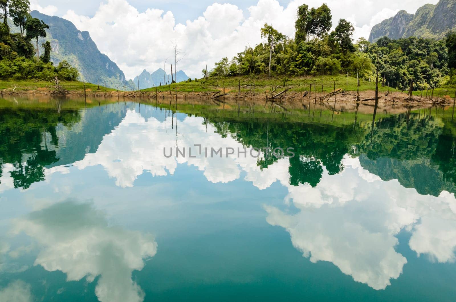 Water surface reflecting sky and cloud at Ratchapapha dam in Khao Sok National Park, Surat Thani province, Guilin of Thailand.