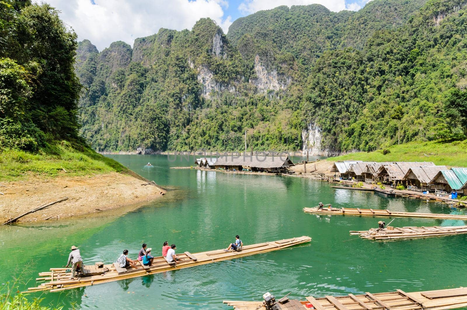 SURAT THANI, THAILAND - APR 26, 2013 : The arrival of tourists to go visit the stalactite cave by motor raft in Ratchaprapha Dam at Khao Sok National Park, APR 26, 2013 in Thailand