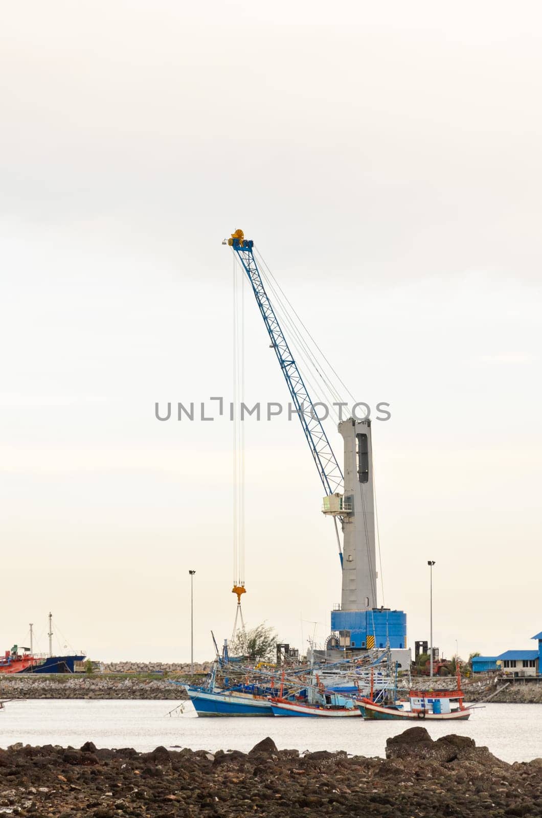 Crane for lifting a load up and down the ship in deep water harbor area of Thailand