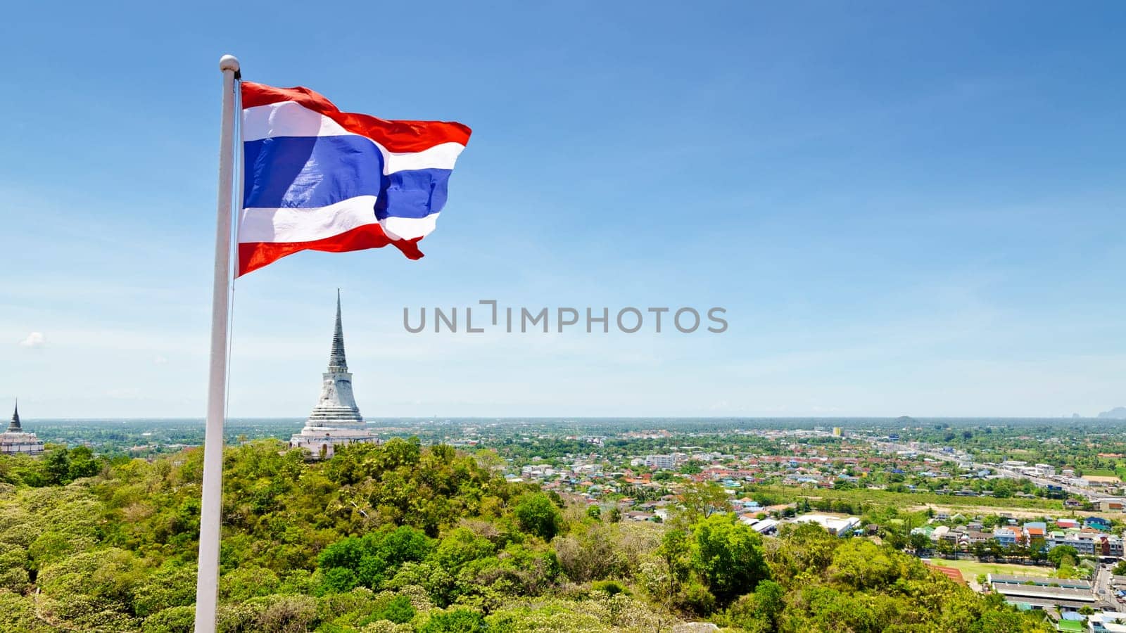 Thai flag waving on mountain in Phra Nakhon Khiri temple, archaeological site of Phetchaburi Province, Thailand.