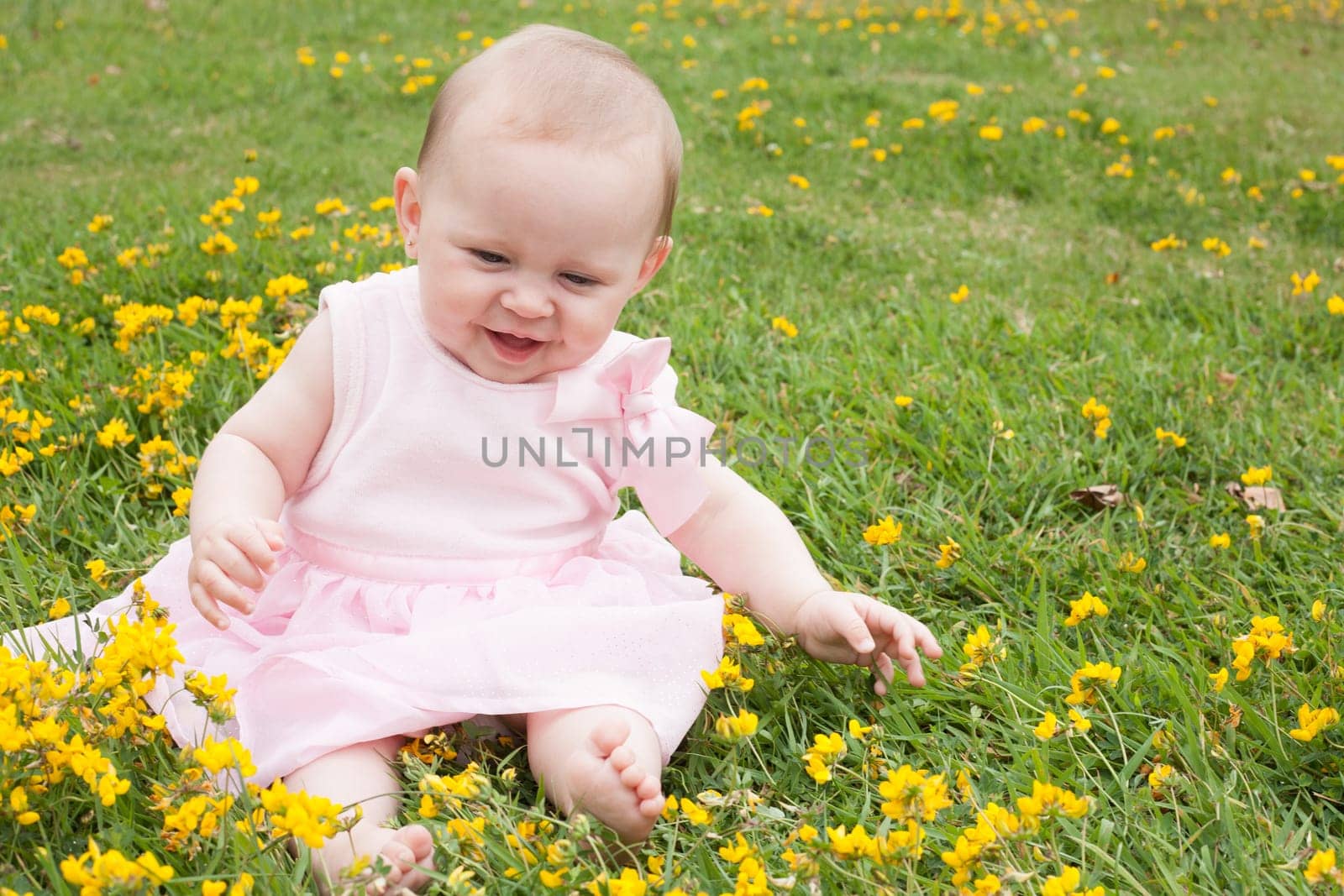 Sweet baby girl in a field of buttercups