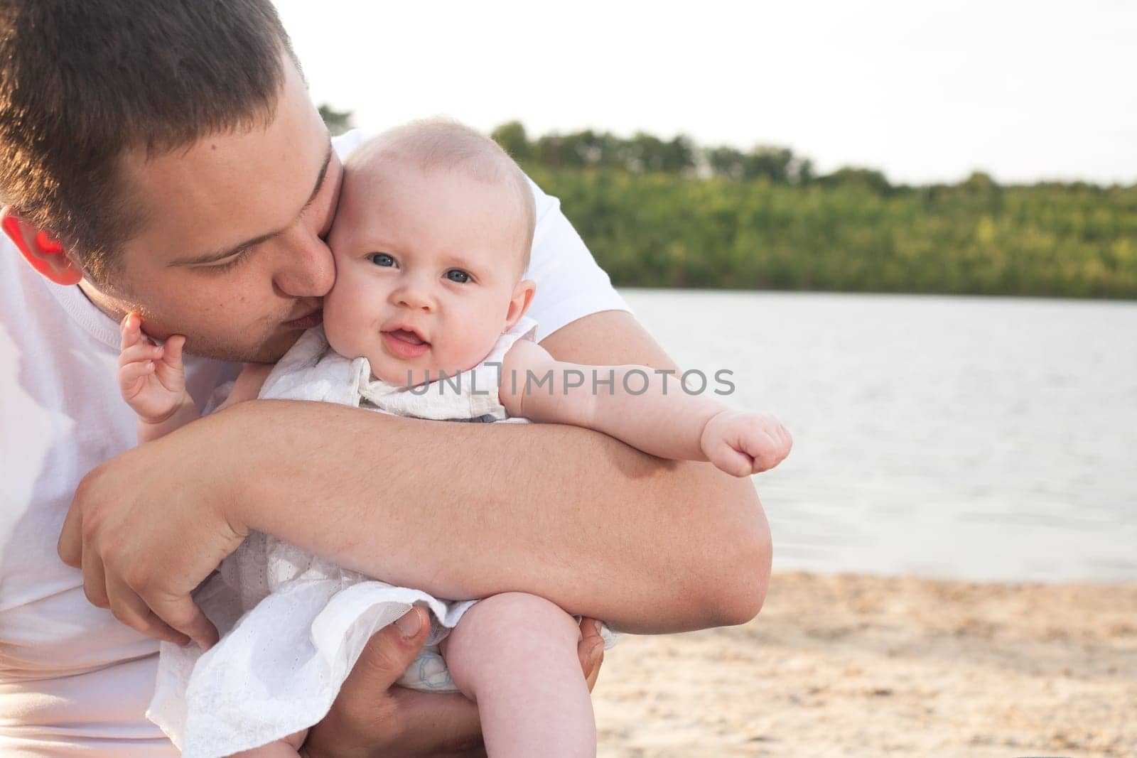 Happy young father is loving his baby