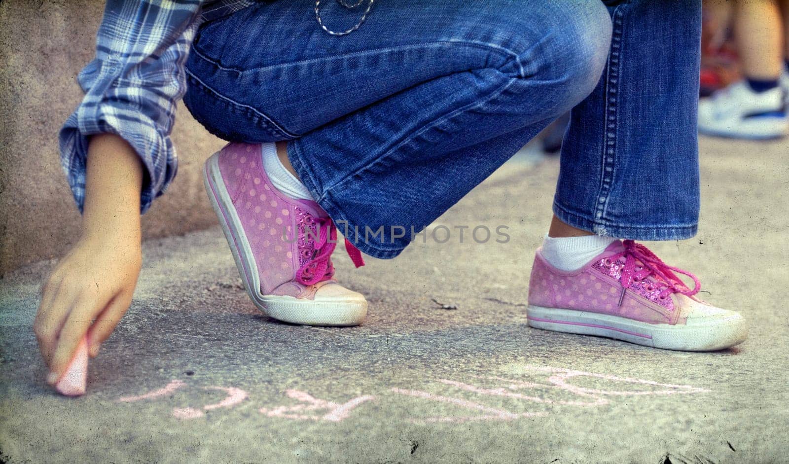 Back to school concept -Photo of girl writing with chalk on the schoolyard