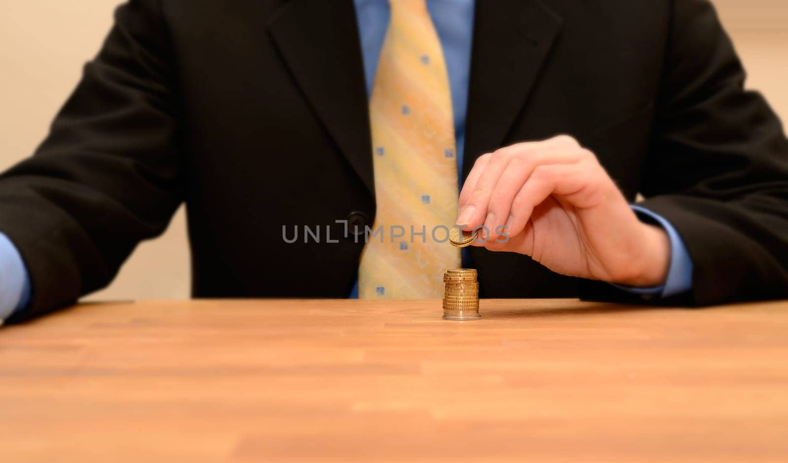 Business man with Euro coins on a table