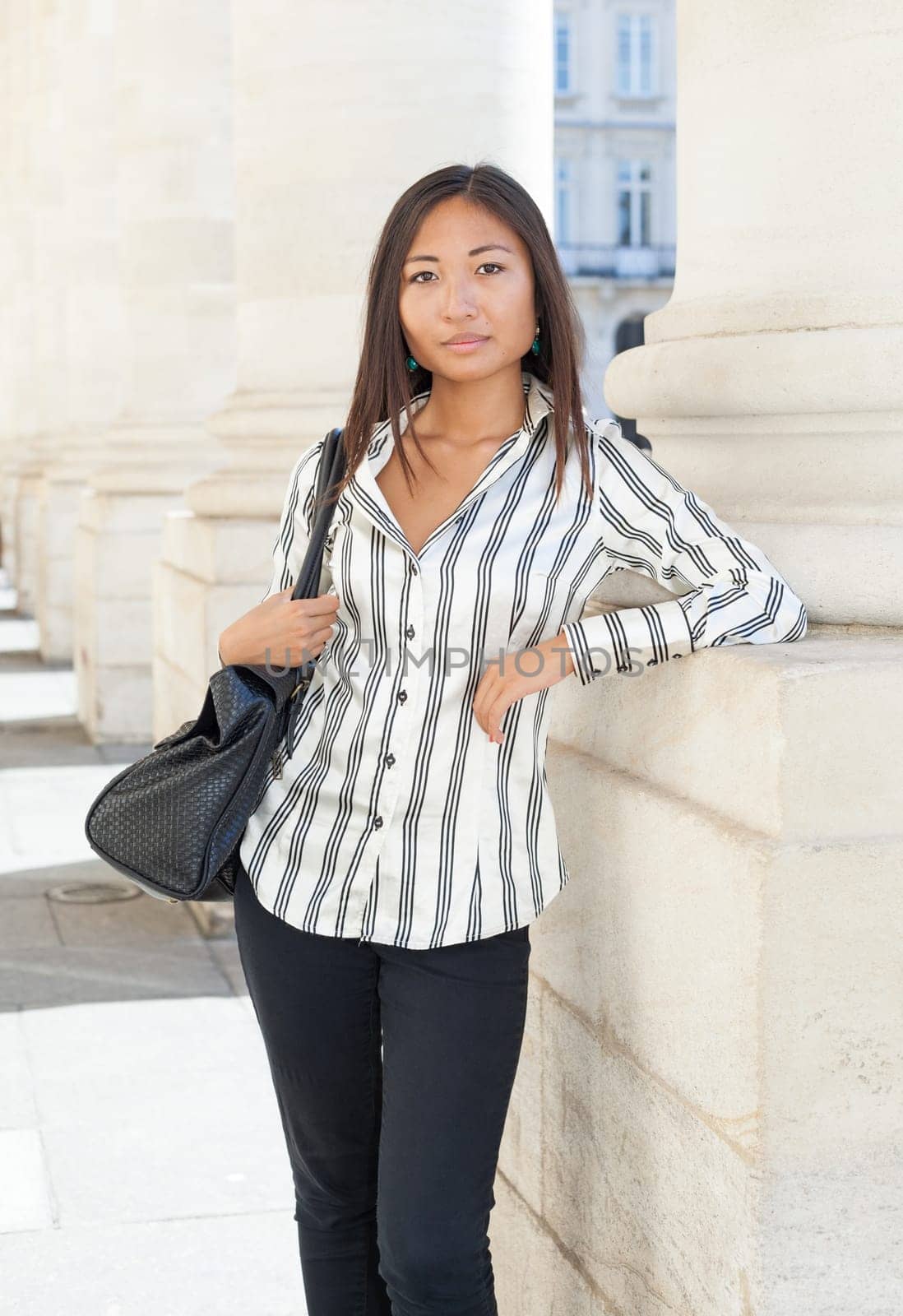Portrait of a young asian girl standing and looking the camera.