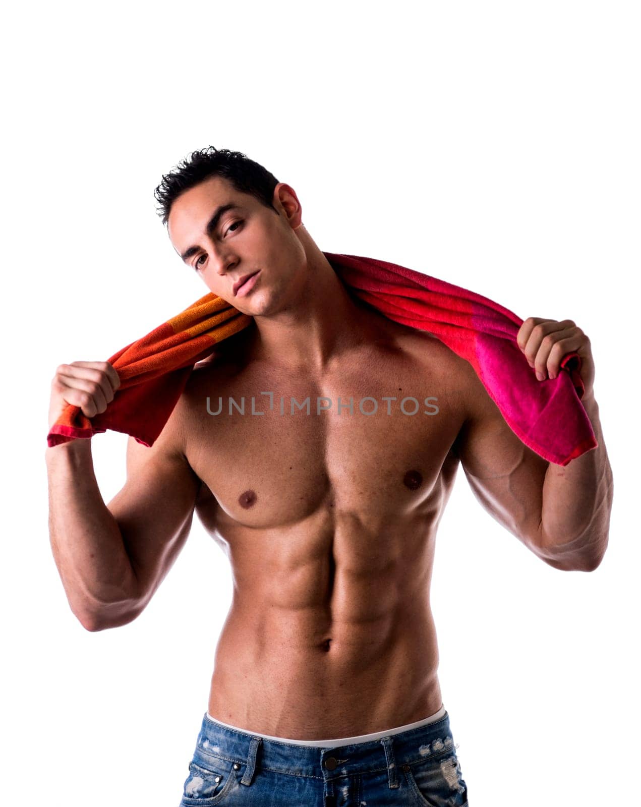 Hunky male model drying himself with a red towel on white background