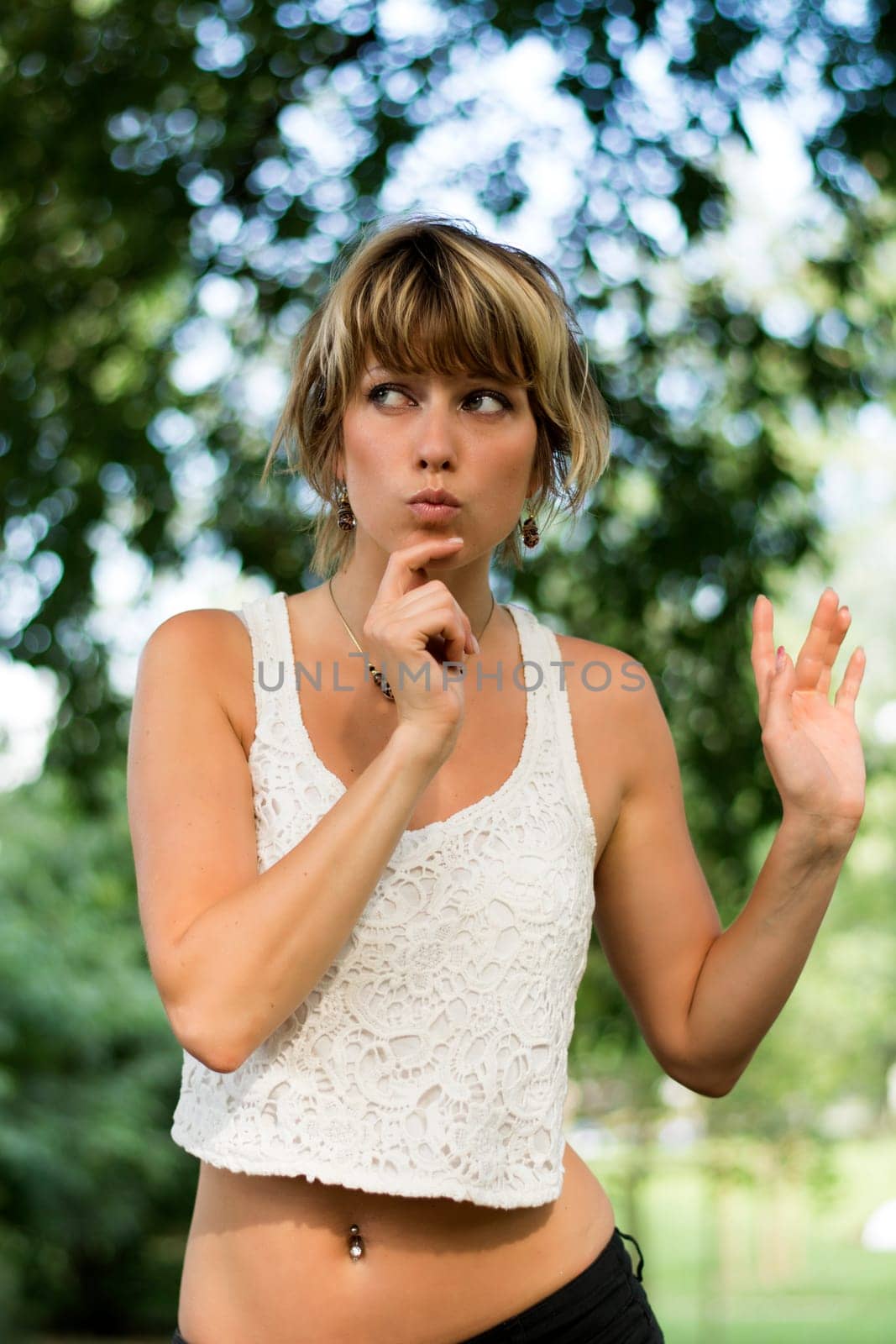 Attractive blonde young woman outdoors with funny expression on her face