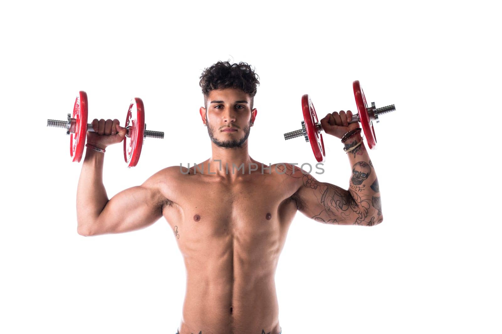 Handsome shirtless muscular young man exercises with dumbbells poses isolated on white