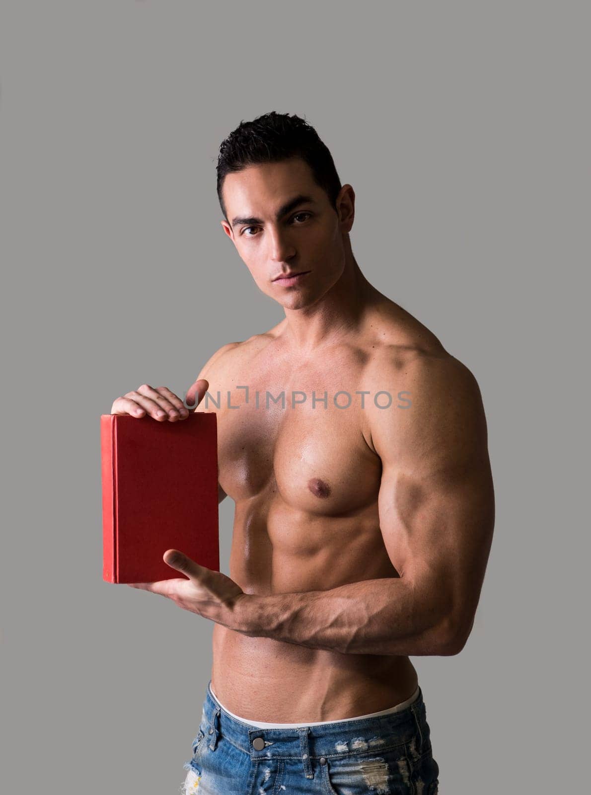 Topless Sexy Man Holding Red Book with Gray Background