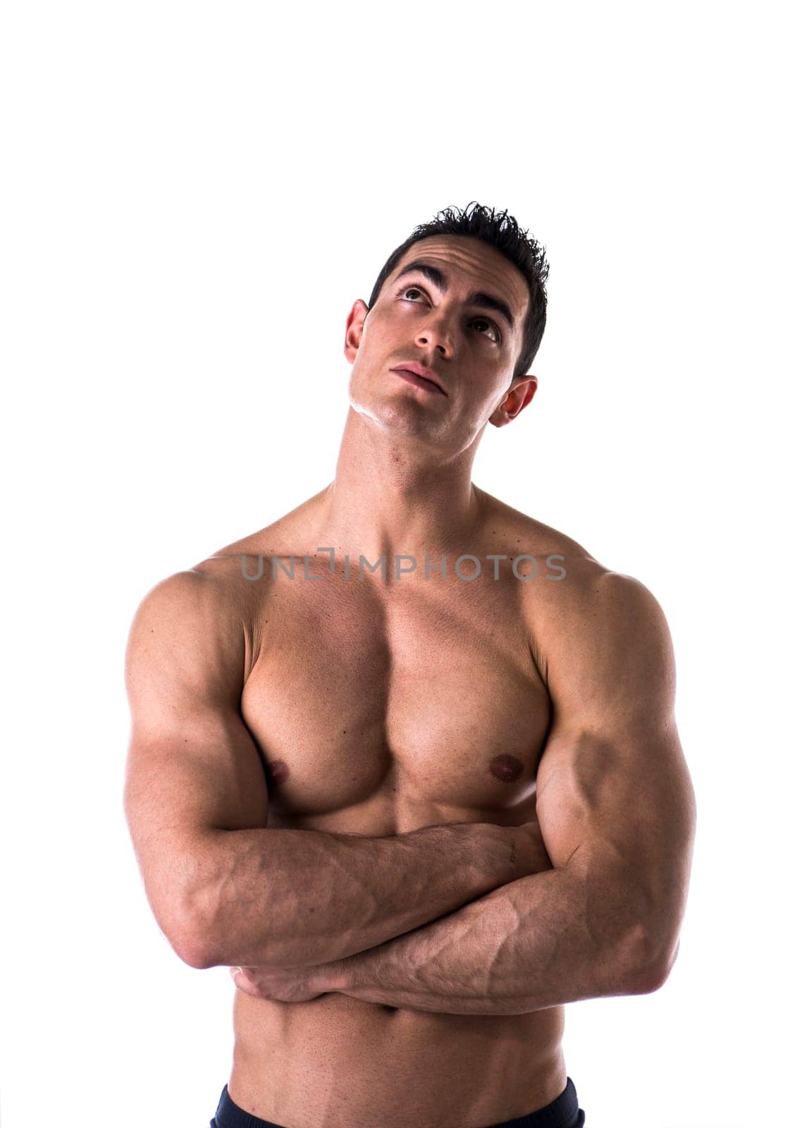 Shirtless man thinking while looking far away on white background