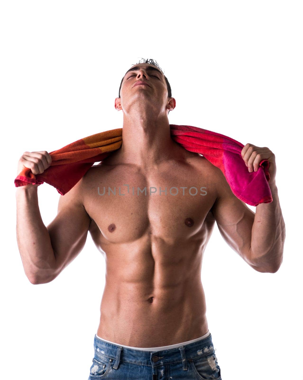 Hunky male model drying himself with a red towel on white background