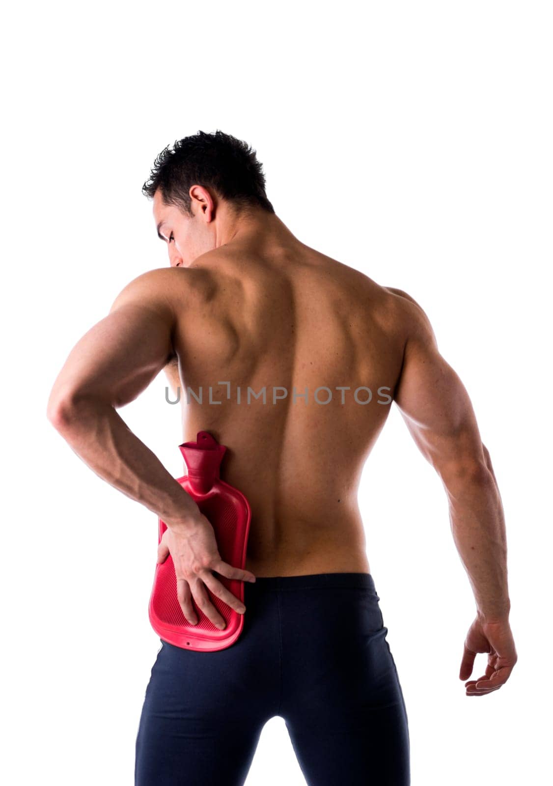 Back of young man with hip or kidney pain, holding hot water bottle, isolated on white