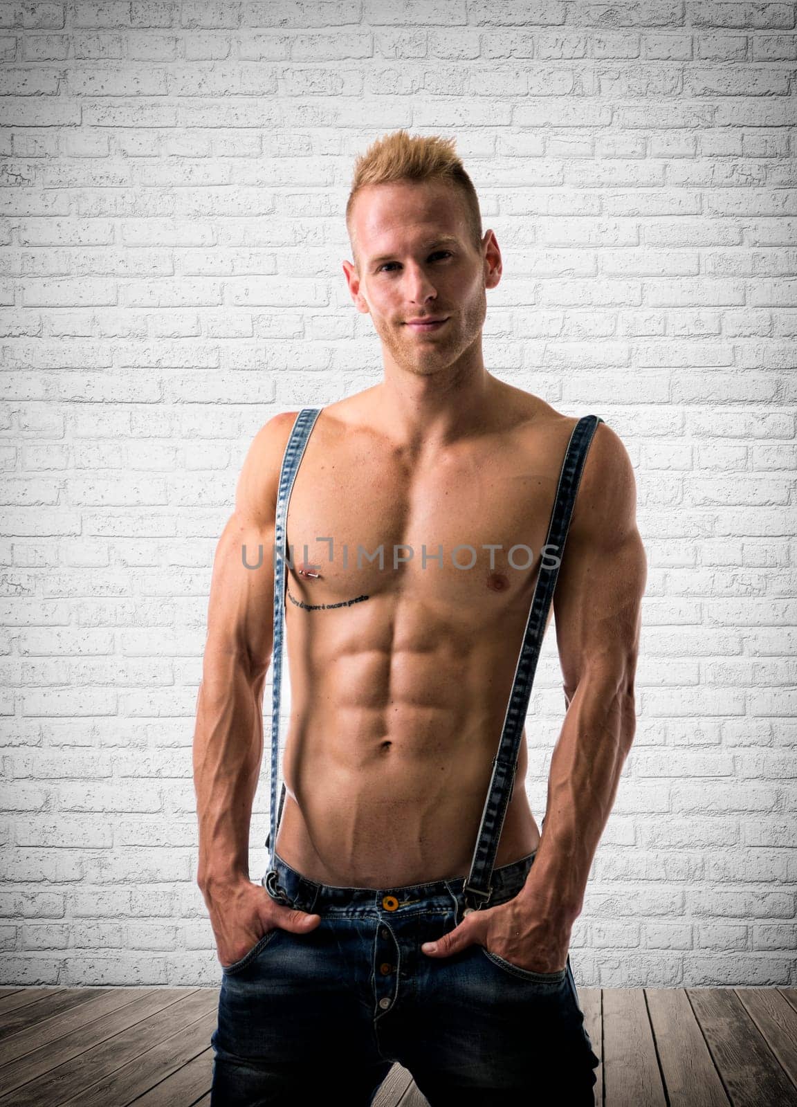Confident male model with a smirk on his face while showing off his muscular body