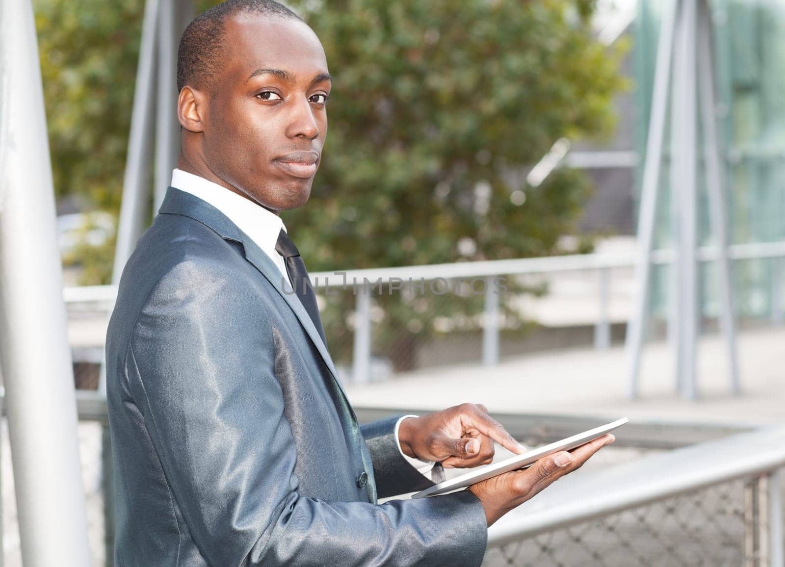 Portrait of a businessman using an electronic tablet