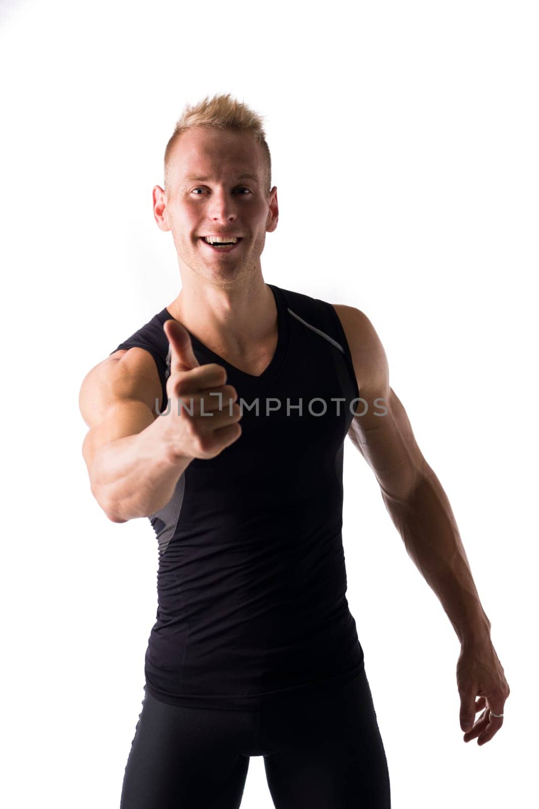 Fit male model with a big smile giving a thumbs up on white background