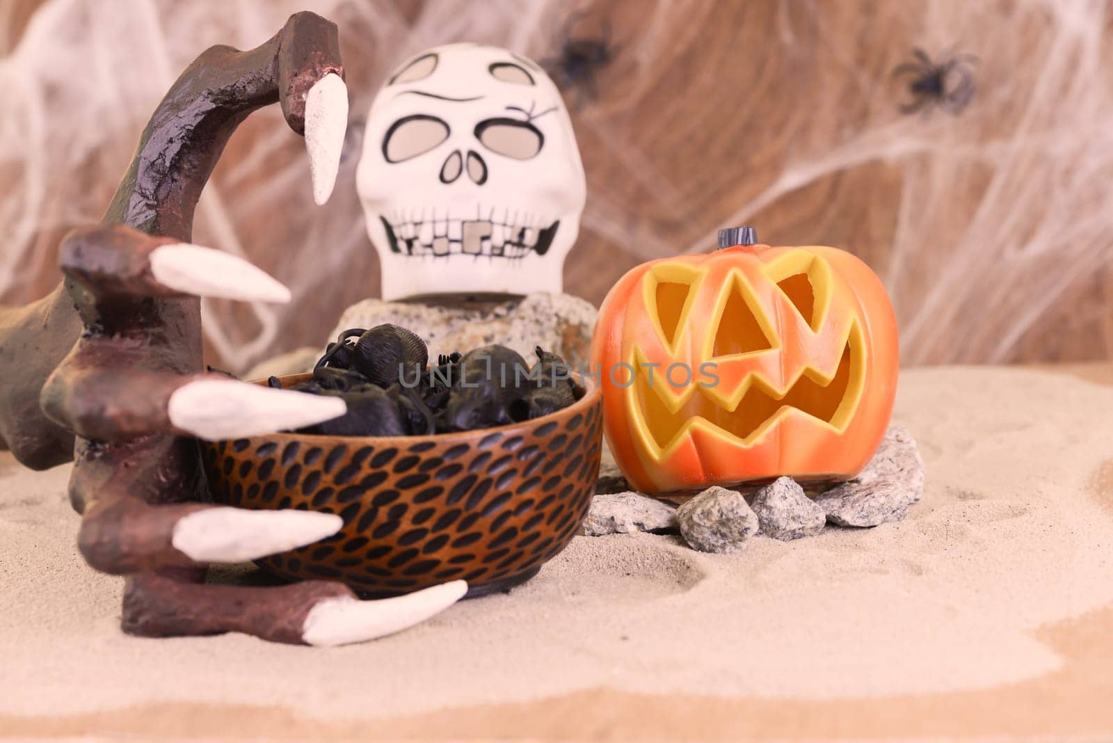 Halloween witch hand reaching for a bowl of rats