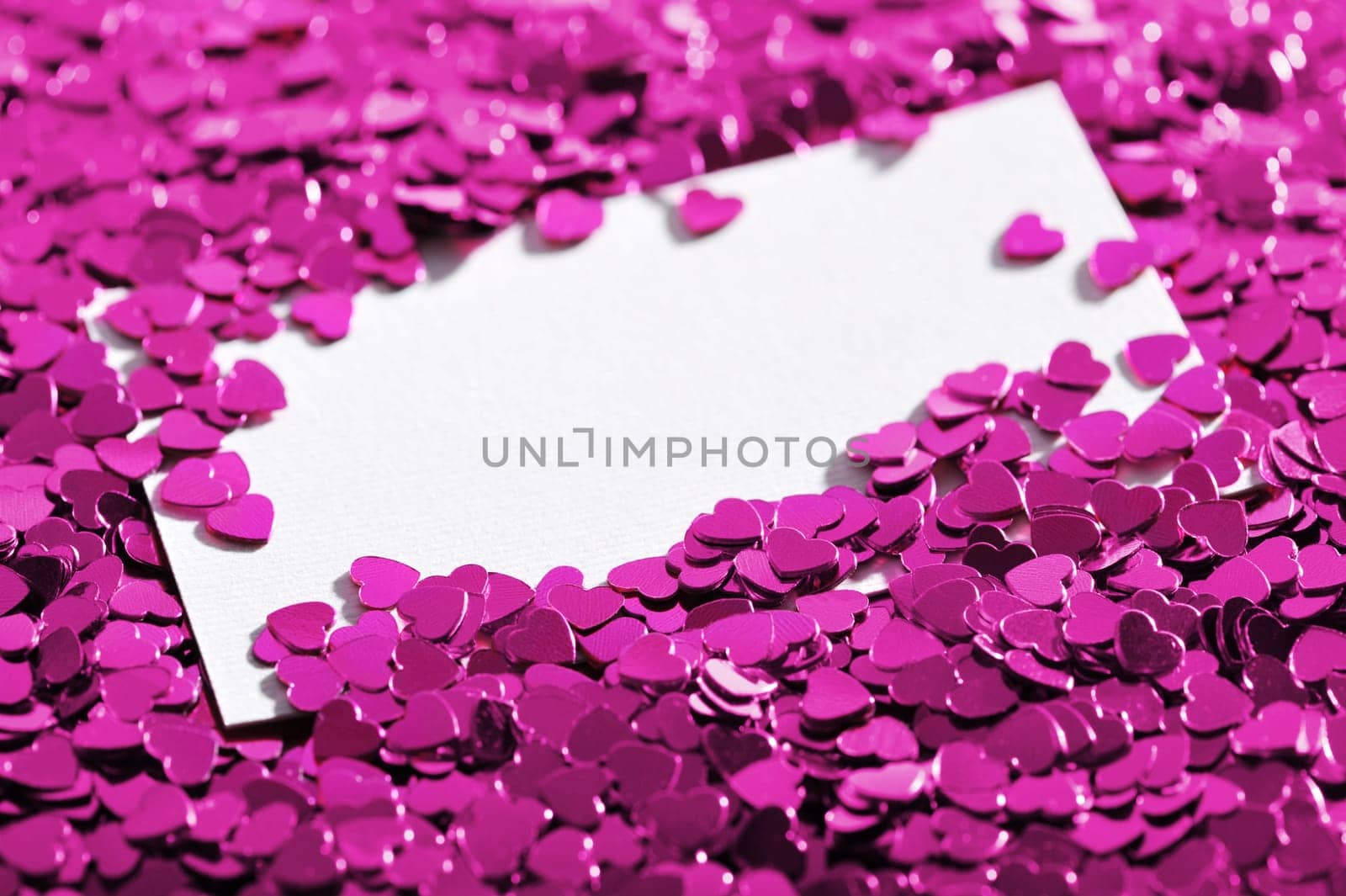 many little pink glitter hearts with white congratulations card