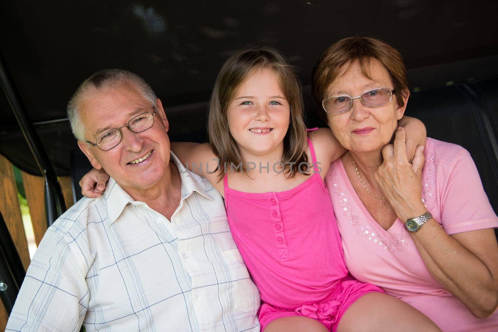 Portrait of grandparents with grandchild (little girl)