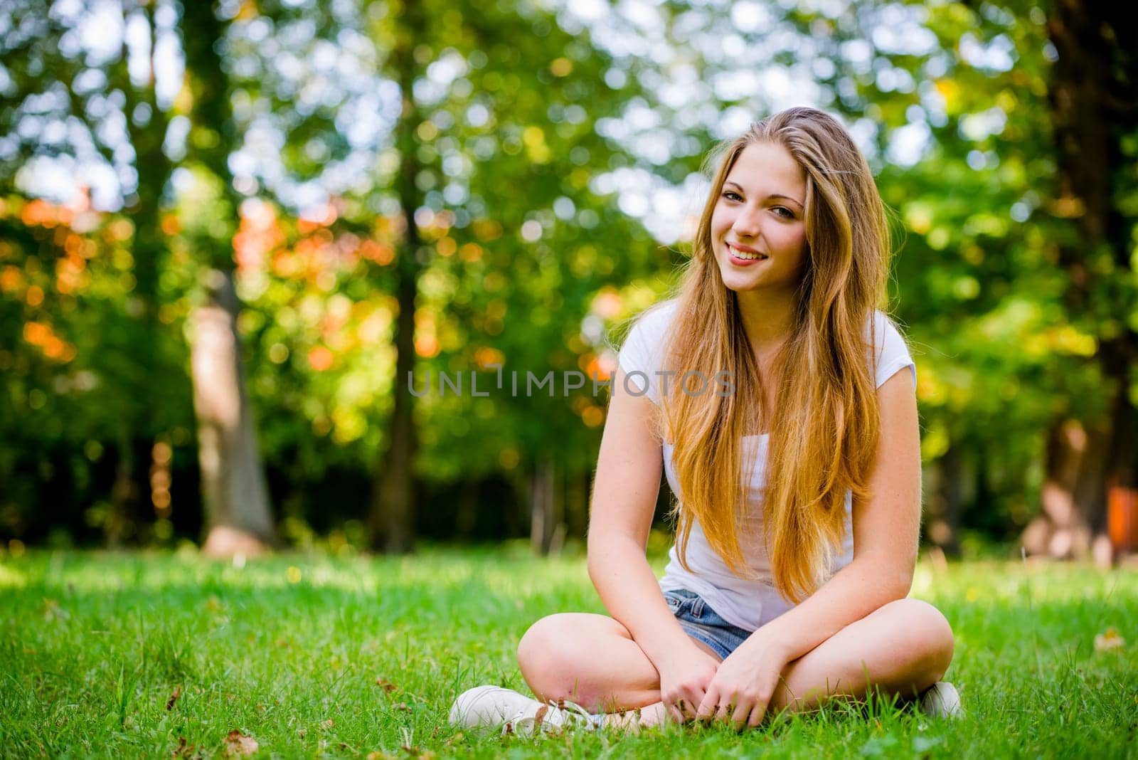 Young beautiful woman (teen girl) looking to side - outdoor in nature