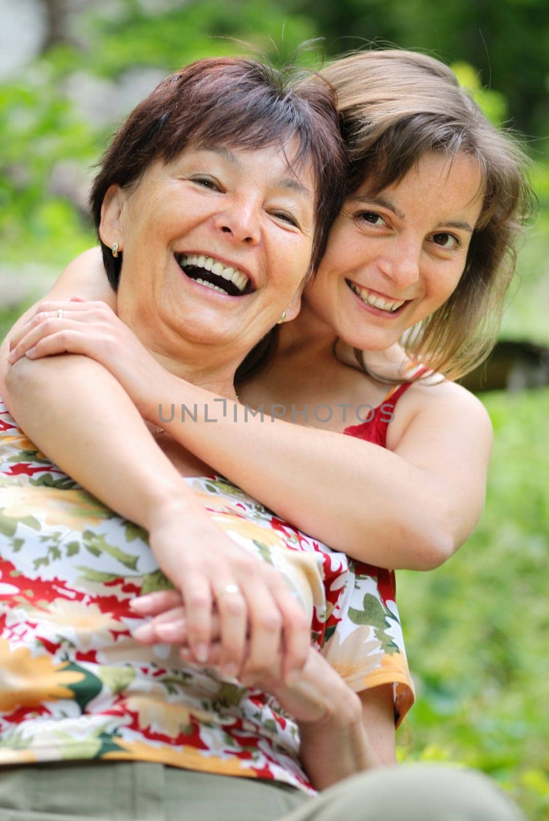 Senior people series - detail of mature woman spending happy time with her daughter outdoors