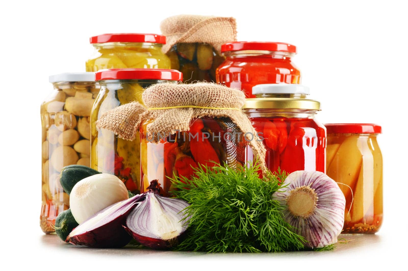 Composition with jars of pickled vegetables. Marinated food