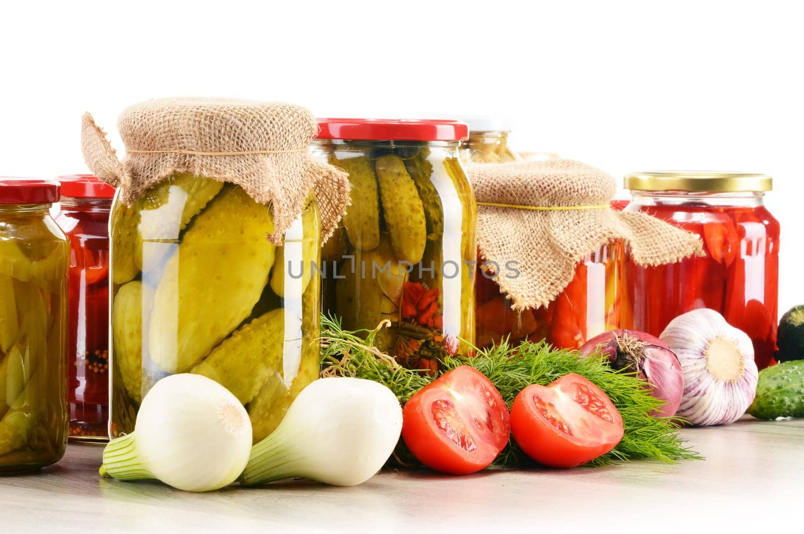 Composition with jars of pickled vegetables. Marinated food