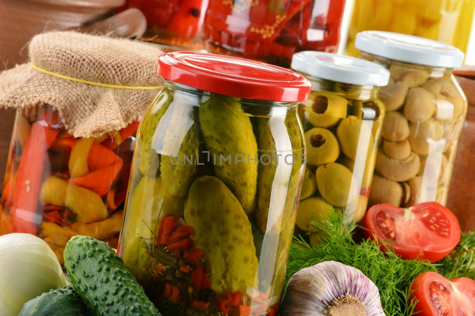 Composition with jars of pickled vegetables. Marinated food