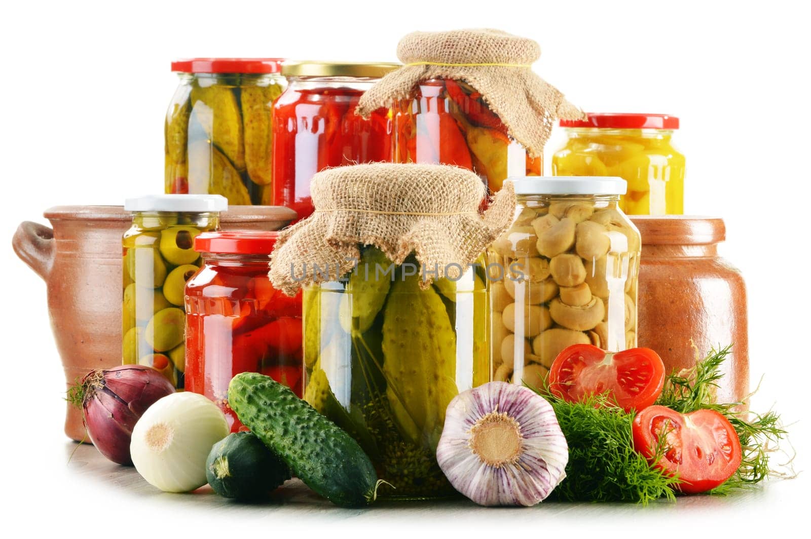 Composition with jars of pickled vegetables. Marinated food