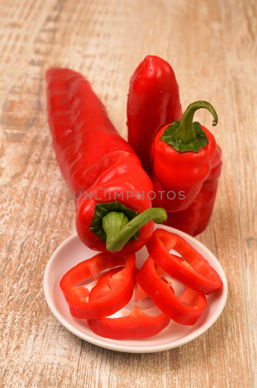 Red fresh paprika on a wooden table
