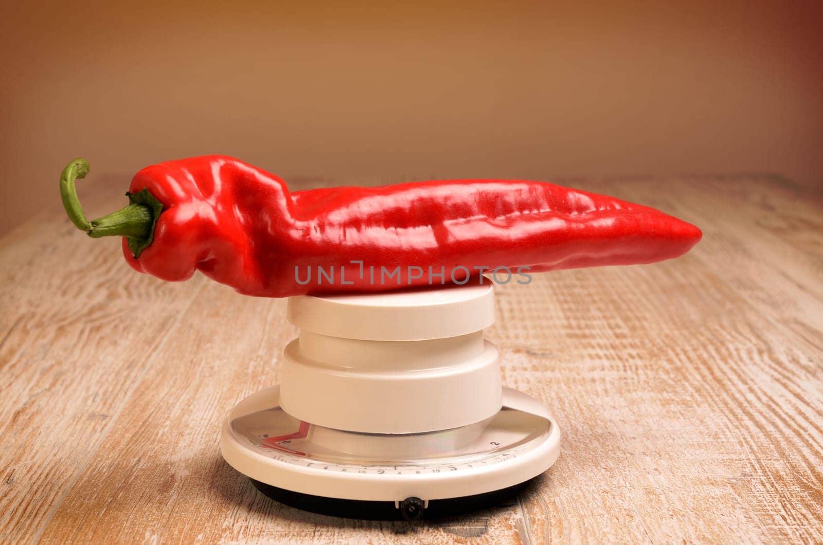 Fresh red paprika on an old used scale